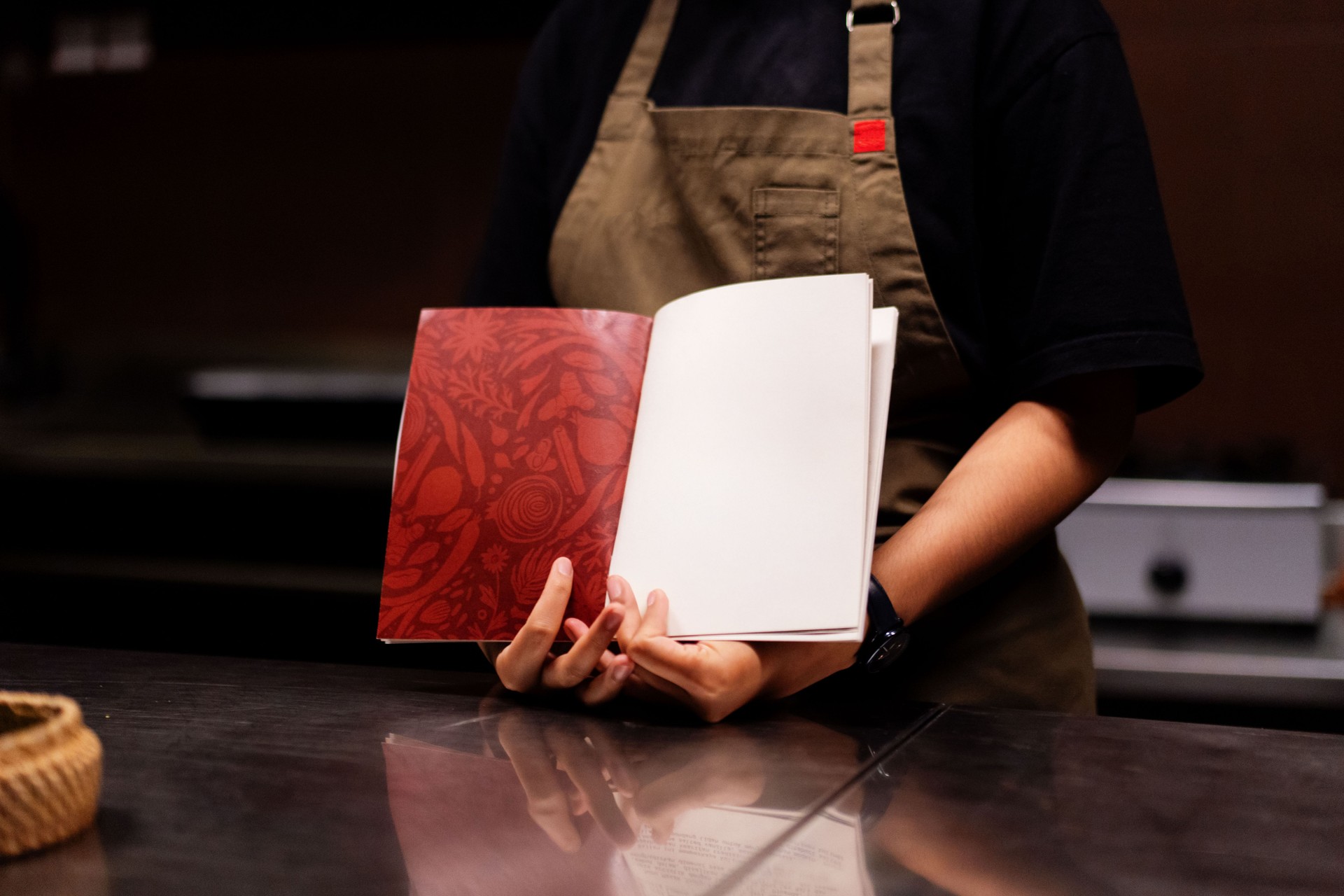 Unrecognizable Chef Holding Empty Menu Book Wearing Apron